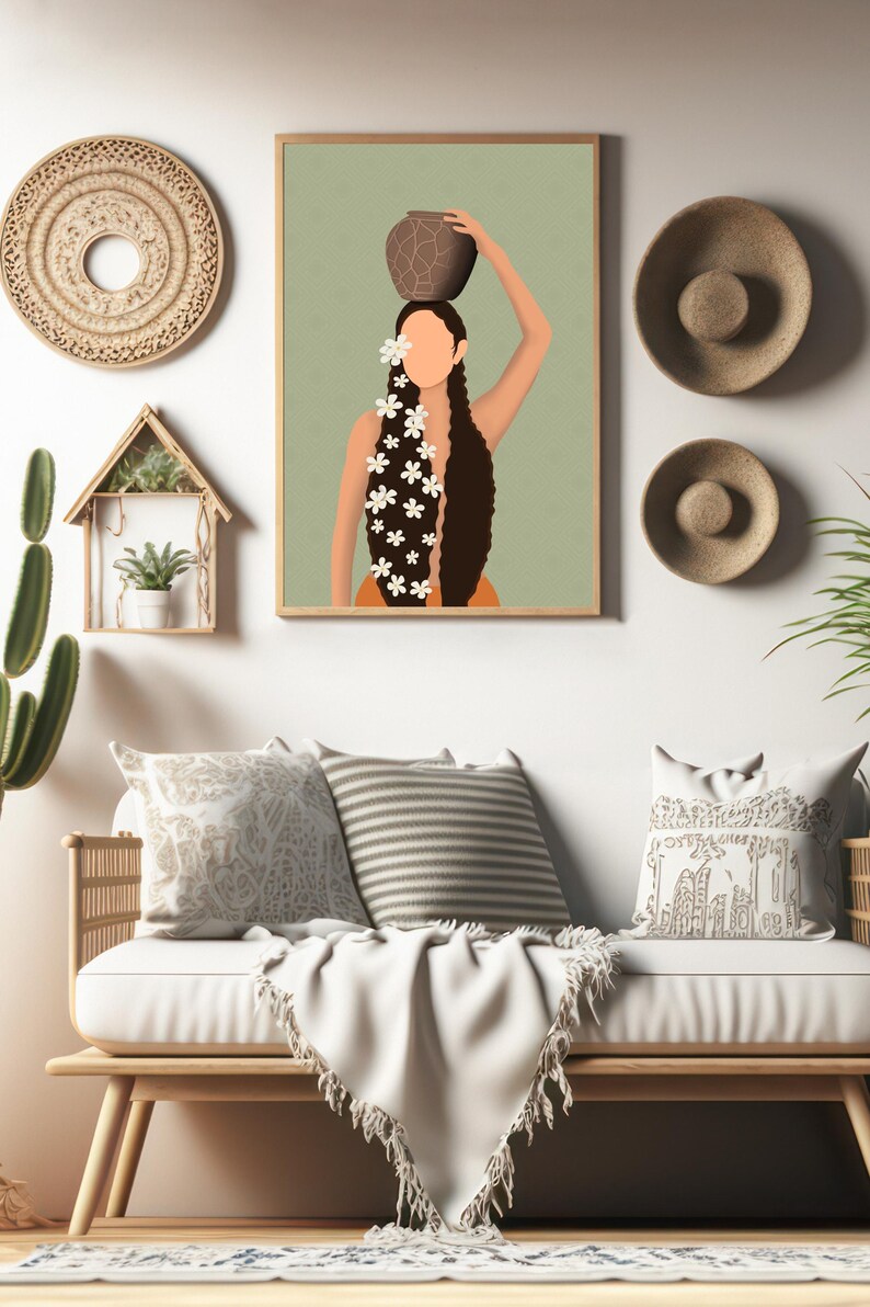 May include: A framed art print depicts a woman carrying a pot on her head, adorned with white flowers in her long, dark hair. The artwork is displayed above a white sofa with decorative pillows and a fringed throw, complemented by woven wall decor.