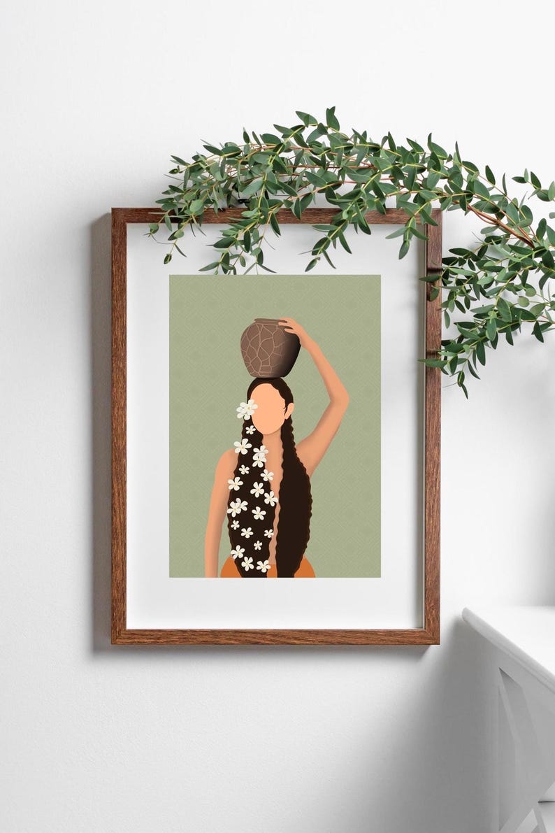 May include: Art print of a woman with long, dark hair adorned with white flowers, carrying a brown pot on her head. The illustration is set against a muted green background and framed in a wooden frame.