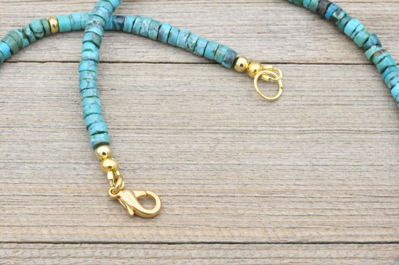 Puede incluir: Un collar de cuentas turquesa con cierres dorados. El collar est&aacute; hecho de peque&ntilde;as cuentas redondas y tiene un dise&ntilde;o simple.