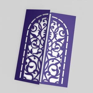 May include: Two indigo-colored, laser-cut paper cards with an arched window design. The intricate pattern features swirling floral and leaf motifs. The cards are slightly offset, revealing the white background. The design is suitable for invitations or decorative purposes.