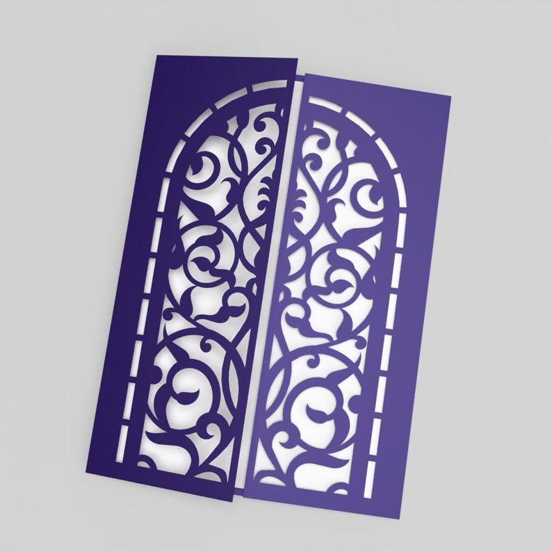 May include: Two indigo-colored, laser-cut paper cards with an arched window design. The intricate pattern features swirling floral and leaf motifs. The cards are slightly offset, revealing the white background. The design is suitable for invitations or decorative purposes.