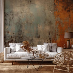 May include: A living room scene with a white sofa, decorative pillows, and a glass-topped coffee table. The wall has a distressed, textured finish in shades of teal, brown, and orange. A woven chair and a lamp with a patterned shade are also visible.