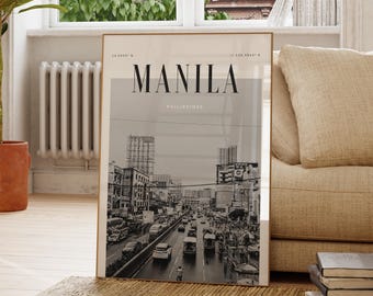 May include: A black and white photograph of a busy street scene in Manila, Philippines. The image is framed in a gold frame and has the text "MANILA" and "PHILIPPINES" printed on it.