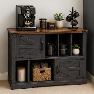 May include: A rustic coffee bar cabinet with a dark gray finish and a brown wood top. It features a coffee maker, coffee beans, mugs, and a small plant. The cabinet has barn-style doors and open shelving for storage.