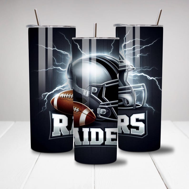 May include: Three stainless steel tumblers with a black and white design featuring a football helmet, football, and the word "RAIDERS".