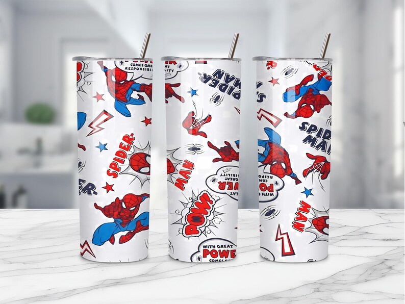 May include: Three white insulated tumblers with a repeating pattern of Spider-Man in action poses, comic book speech bubbles, and text. The design includes red, blue, and black elements. Each tumbler has a silver straw.