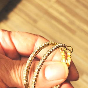Earrings loop earrings with rhinestones. Gold plated.