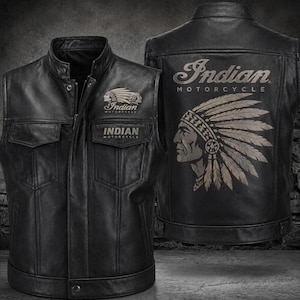 May include: A black leather motorcycle vest featuring a front zipper, snap buttons, and two chest pockets. The front displays an Indian Motorcycle logo. The back features a large graphic of a Native American headdress and the text Indian Motorcycle.