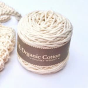 May include: A ball of natural white organic cotton yarn with a brown label that reads "Organic Cotton" and "Skinny Weight".