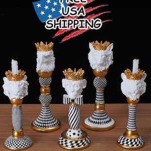 May include: Five decorative candle holders with animal head designs, including a lion and monkey, topped with gold crowns. The candle holders have black and white checkered and striped patterns, with gold accents. The image includes the text "FREE USA SHIPPING".