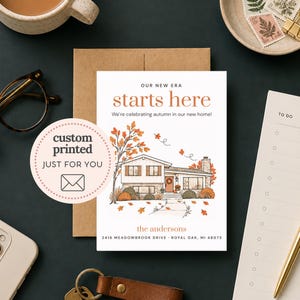 May include: A white rectangular moving announcement card featuring an illustration of a house with autumn trees and falling leaves. Text reads: OUR NEW ERA starts here, We're celebrating autumn in our new home!, the andersons, 2416 MEADOWBROOK DRIVE.