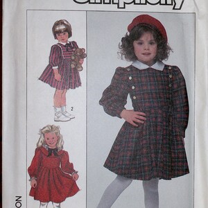 May include: Simplicity sewing pattern 8324 size 6 featuring illustrations of three dress variations. The designs include a plaid dress with a white collar and buttons, a striped dress with a bow, and a solid red dress with a black bow and lace trim.
