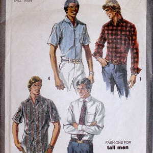 May include: Simplicity 8711 sewing pattern for tall men's fashions. The cover shows illustrations of four shirt styles: a striped short-sleeve shirt, a plaid long-sleeve shirt, a patterned short-sleeve shirt, and a collared shirt with a tie. Measurements are in cm.
