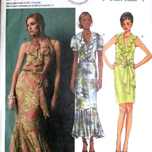 May include: A sewing pattern for a dress with a ruffled neckline and a tie at the waist. The pattern is for sizes 6-8-10-12-14 and is from Butterick pattern number B5879.