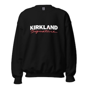 May include: Black crewneck sweatshirt with the white text "KIRKLAND" above the red cursive text "Signature". The sweatshirt is a solid black color.