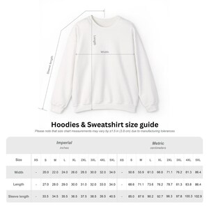 May include: White sweatshirt with a size chart. The chart includes measurements in inches and centimeters for width, length, and sleeve length. The width ranges from 20.0 to 34.0 inches, and the length ranges from 27.0 to 34.0 inches.