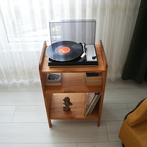 Vinyl record storage shelves in a wooden cabinet, organizing LP albums in a Mid-Century Modern Record Holder Stand