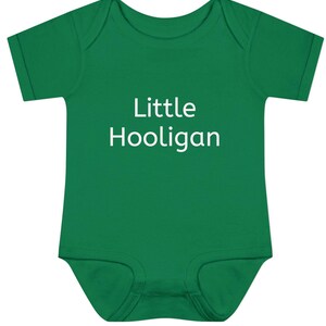 May include: A green baby onesie with white text that reads "Little Hooligan".