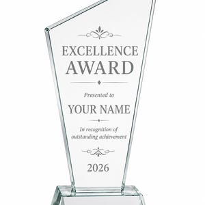 May include: A clear glass award trophy with a slanted top edge and a rectangular base. The front surface features etched text reading EXCELLENCE AWARD, Presented to YOUR NAME, In recognition of outstanding achievement, and the year 2026.