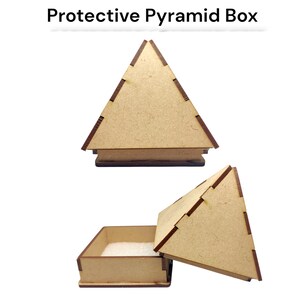 May include: A protective pyramid box made of light brown wood, with a contrasting darker brown trim. The box is shown both closed and open, revealing a square base and a pyramid-shaped lid. The text "Protective Pyramid Box" is above the box.