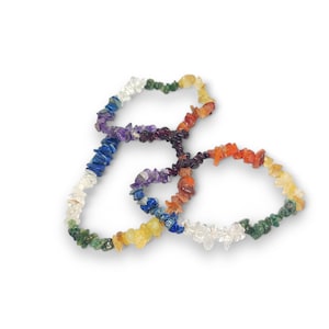 May include: Three bracelets made of small, chipped gemstones in a rainbow of colors. The bracelets are made of clear quartz, green aventurine, yellow citrine, orange carnelian, red jasper, purple amethyst, blue lapis lazuli, and indigo sodalite.
