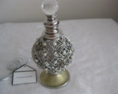 Perfume display decorated bottle, silver wire and faux pearls decor. 4.5 quot x 2.5 quot , screw on stopper w glass ball. Elegant.