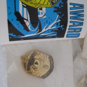 National safety council safe driver award, year 4 pin. In original plastic wrap with the original award tag, Dated 12/12/91
