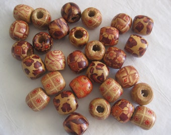 May include: A collection of wooden beads in various shapes and sizes, featuring intricate patterns. The beads are primarily light brown with dark brown and red floral and geometric designs. These decorative beads are perfect for jewelry making and crafts.