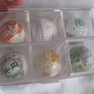Vintage novelty, money golf balls covered with diff. country's paper bills, collectibles, golfers gift. Set of 6 in clear display boxes.