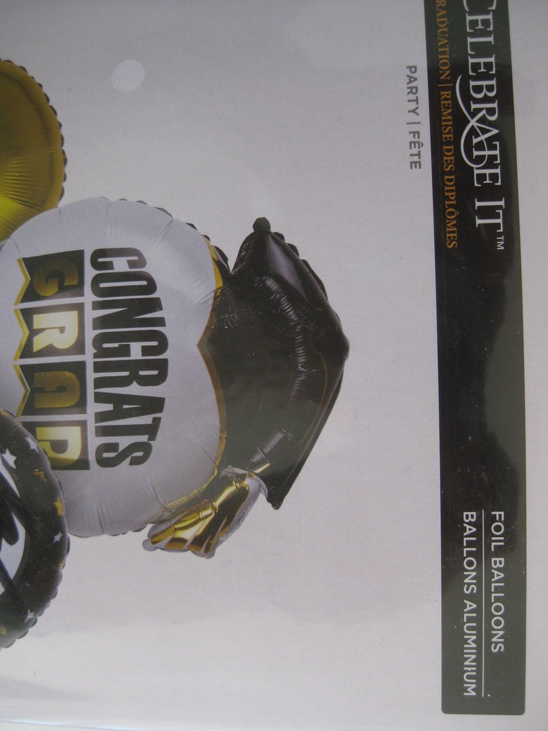 Graduation foil balloons and 2 gold foil balloons 18. 1 w Congrats Grads printed and a cap 26