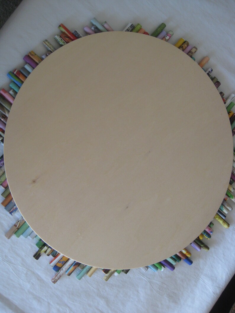 Round mirror surrounded by a collage of colorful upcycled Etsy