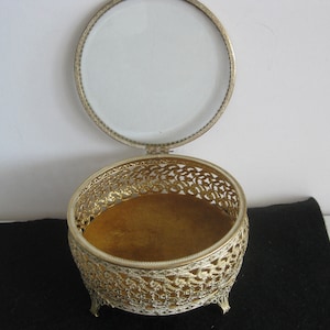 Mid century filigree gold tone ornate footed jewelry/trinket box, glass top, velvet bottom. 5&quot; diam.x3&quot; tall, vintage, in perfect condition.