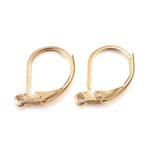 May include: Two gold-toned earring hooks, also known as ear wires, are shown against a white background. The hooks are made of metal and have a teardrop shape.