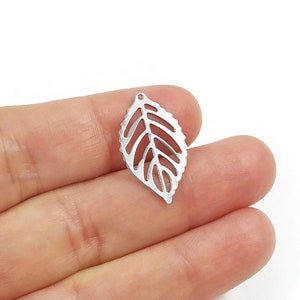 May include: A silver leaf charm with a delicate cutout design. The charm is ideal for adding a touch of nature to jewellery projects.