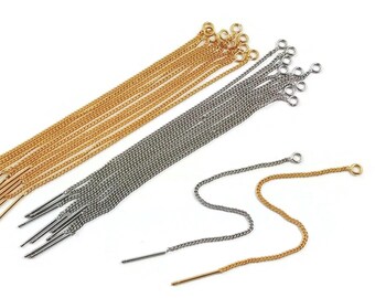 May include: A set of gold and silver chain earrings. The earrings are long and have a delicate chain design. They are perfect for adding a touch of elegance to any outfit.