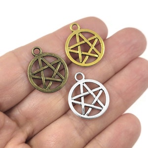 May include: Three silver and gold pentagram charms with a five-pointed star design. The charms are round and have a loop at the top for attaching to jewellery or other crafts.