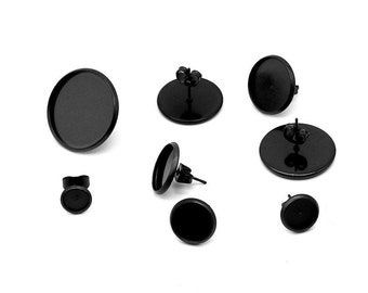 May include: Seven black earring settings with round bezels. The settings are made of metal and have a post back.