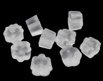May include: A group of ten clear plastic earring backs. The backs are shaped like a flower with five petals.