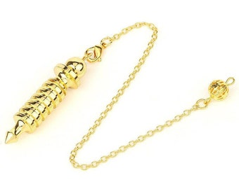 May include: A gold-colored metal pendulum with a spiral design and a pointed tip. The pendulum is attached to a gold chain with a small ball at the end.