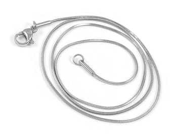 May include: A silver snake chain necklace with a lobster clasp closure.