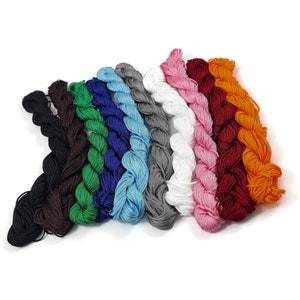 May include: Assortment of 10 spools of waxed cotton cord in various colours, including black, brown, green, blue, light blue, grey, white, pink, red, and orange.