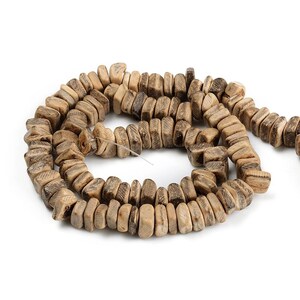 May include: A strand of natural-toned wooden beads. The beads are rectangular with rounded edges and a textured surface, strung together on a thin wire. The color varies from light tan to darker brown.