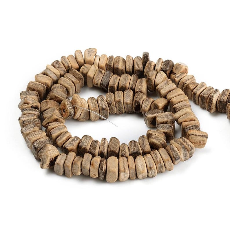 May include: A strand of natural-toned wooden beads. The beads are rectangular with rounded edges and a textured surface, strung together on a thin wire. The color varies from light tan to darker brown.