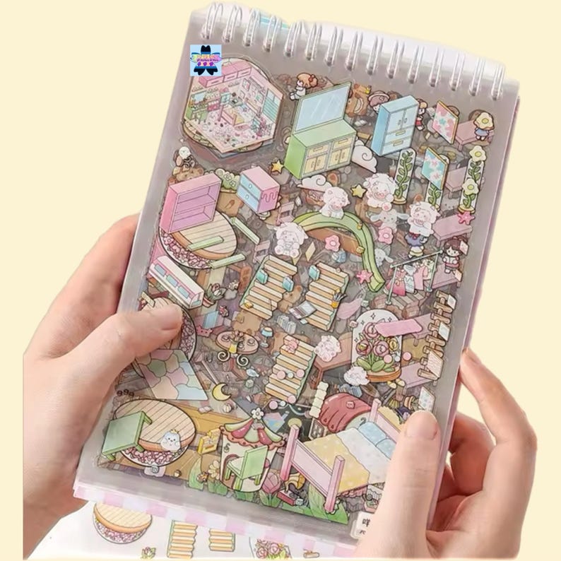 May include: A spiral bound notebook with a clear plastic cover featuring a colorful illustration of a whimsical house with various rooms and furniture. The illustration is filled with details and includes a variety of objects, such as a bed, a table, a chair, a lamp, and a window.