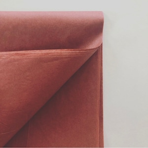 May include: A folded sheet of terracotta tissue paper.