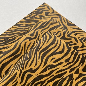 May include: Brown and black tiger stripe patterned wrapping paper.