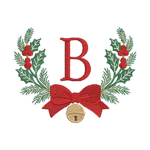 May include: Embroidered Christmas wreath design with the letter "B" in red. The wreath features green holly leaves, red berries, and a red bow with a gold bell. Festive holiday design.