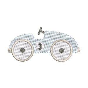 May include: Embroidered light blue race car with white wheels and the number 3 on the side. The car has a small black steering wheel and is designed with a textured fabric appearance. A charming design for children's apparel or decor.