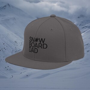 May include: A grey and black baseball cap with the text "SNOWBOARD DAD" embroidered on the front.