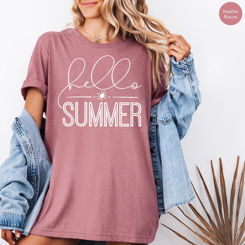 May include: A heather mauve t-shirt with the text "hello summer" in white lettering. The text includes a small sun graphic.